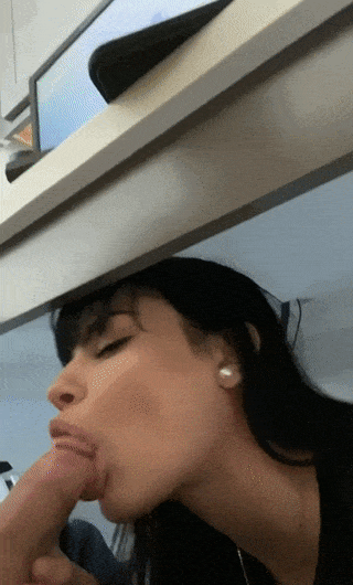 black haired hottie sneaks a blowjob from under a desk nsfw xxx gif